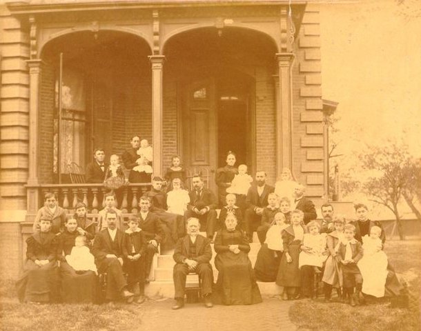 photograph of extended Hermann Wilhelm & Sophia (Gusewelle) Fiegenbaum family posed outside the home of Dr. Edward William Fiegenbaum