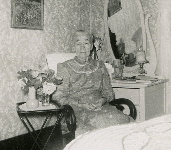 photograph of Henriette C. A. (Starkebaum) Fiegenbaum seated in a rocking chair in her bedroom