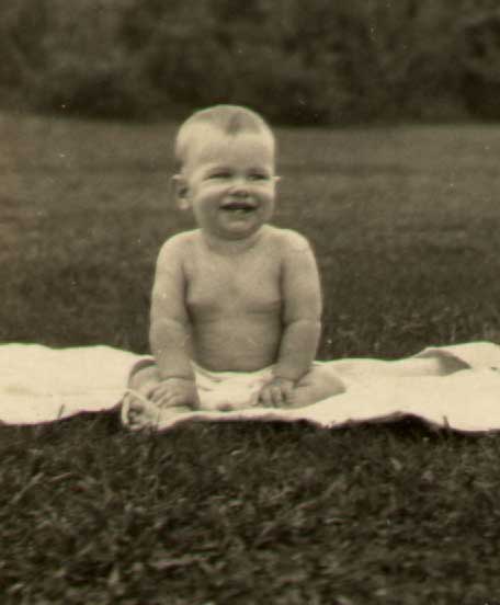 photograph of J. W. Fiegenbaum at age 6 months sitting on a blanket in the grass