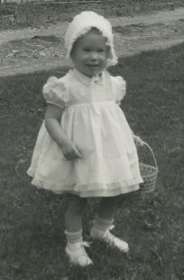 photograph of a very young Karen J. Fiegenbaum collecting Easter eggs