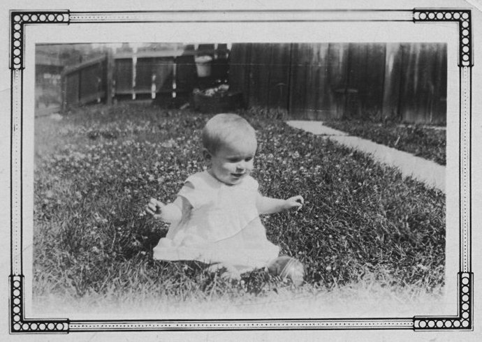 photograph of a very young Dorothy May Gerber playing with a ball in the back yard