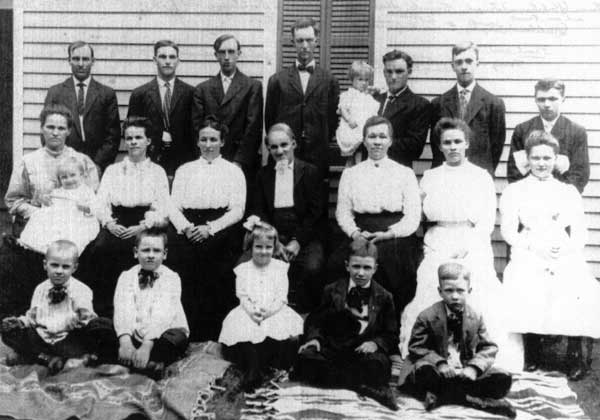 members of the extended Starkebaum family pose outside in February 1911