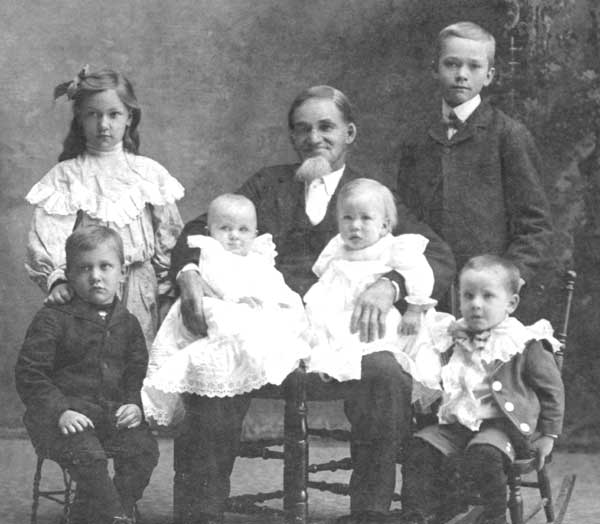 photographic studio portrait of Heinrich Friederich L. Starkebaum with some of his young grandchildren