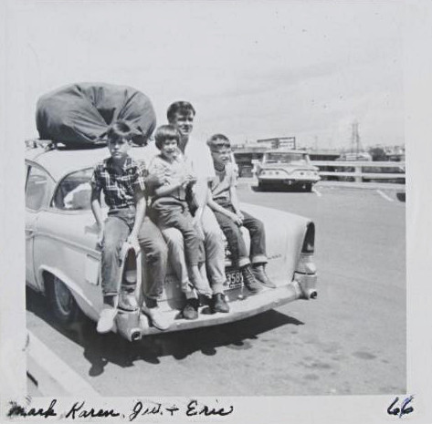 photo of the 1956 Studebaker with possessions packed on the roof and family members sitting on the truck